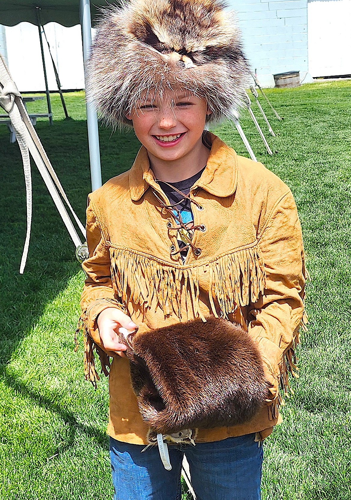 Young trapper Miles shows off the otter pelt he traded for at Campbell Fine Furs. (Berl Tiskus/Leader)