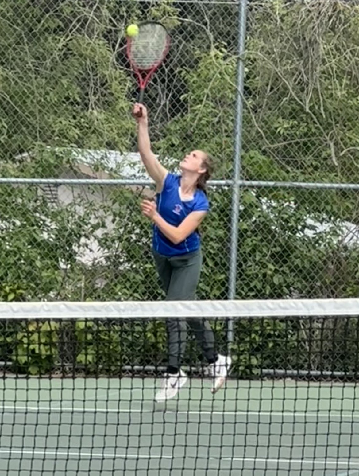 Superior sophomore Josie Crabb hits an overhead return during a match at this past weekend's Western divisional tournament in Missoula. (Photo by Perri Jasper)