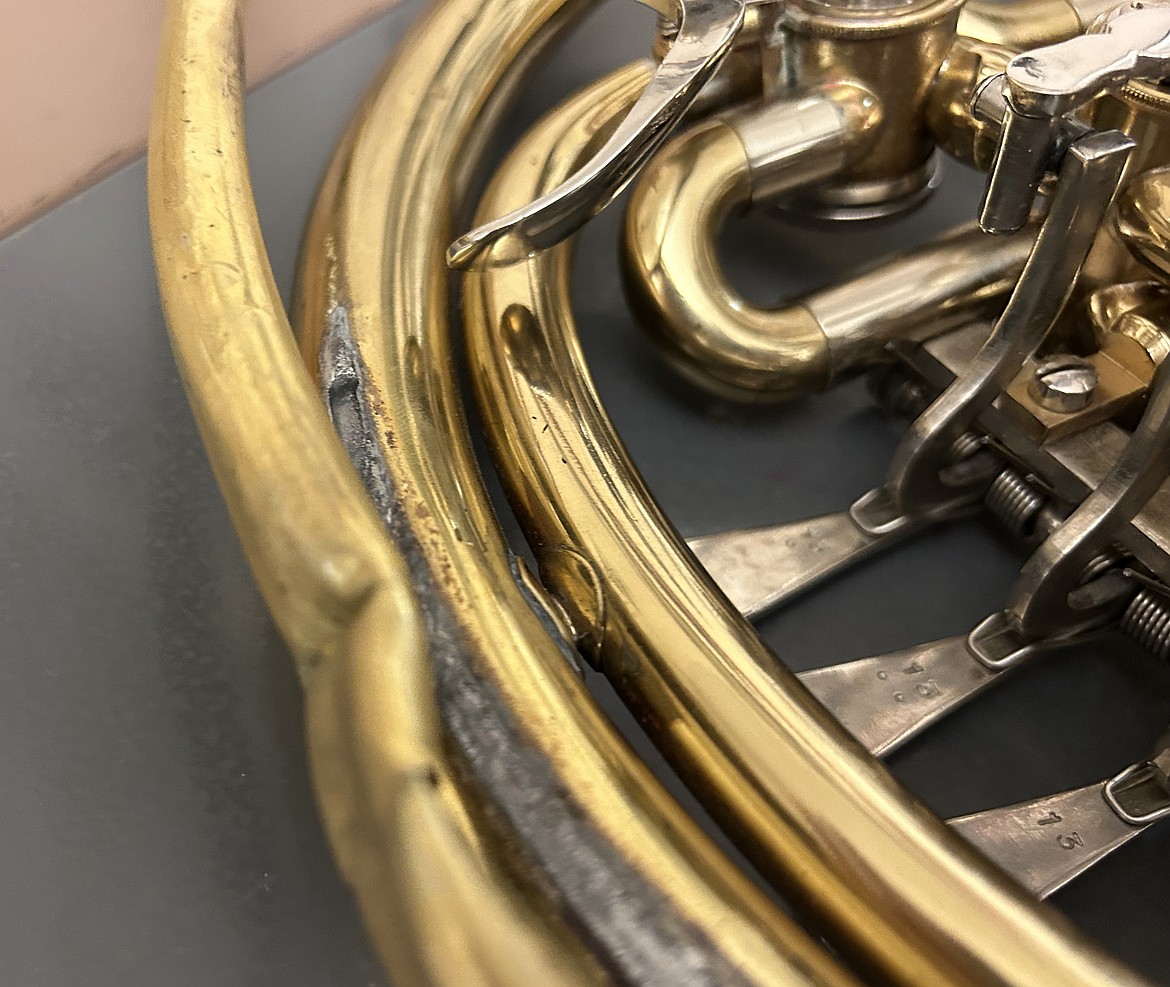 This past week, a french horn was laid to rest as its decaying lead pipe cracked and separated from the instrument. (Photo by Mark McCrady)