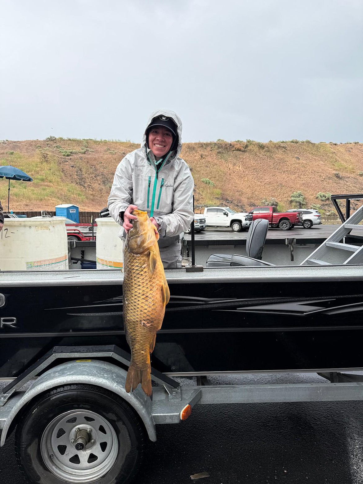 Jennifer Novak shows her prize-winning carp weighing almost 26 pounds at the Carp Classic Saturday.