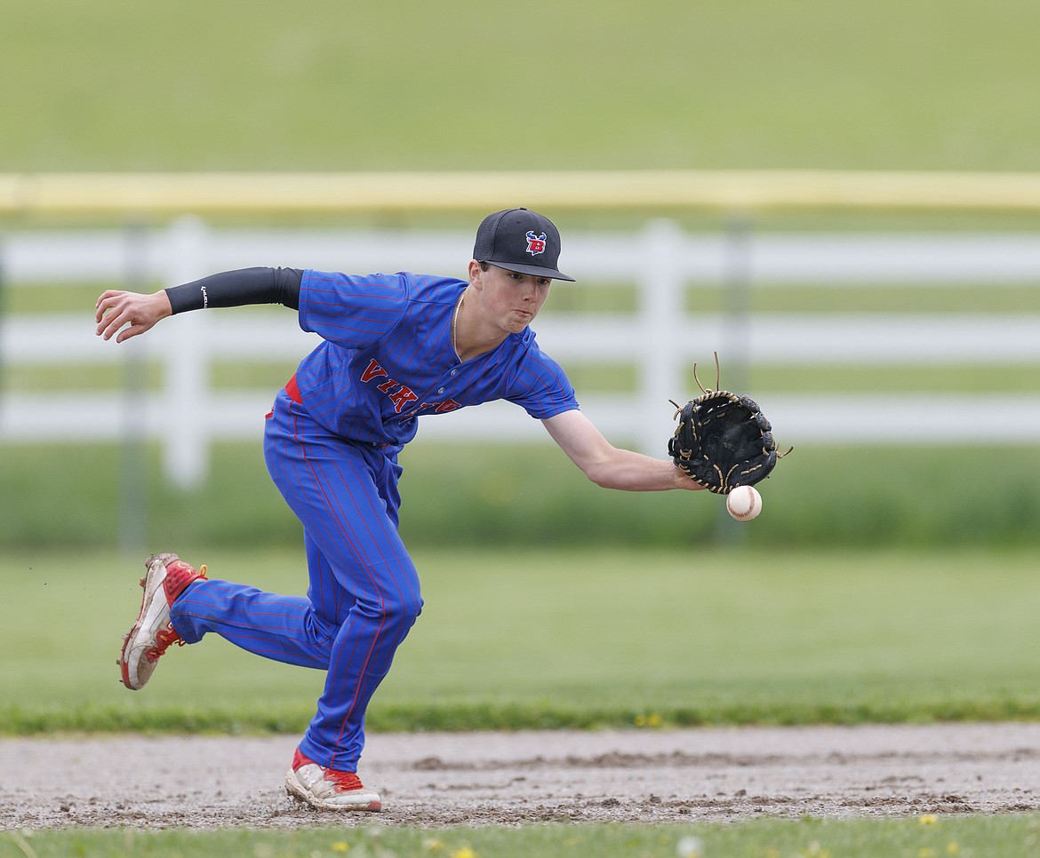 Bigfork's Grady Campbell slides in safe against Corvallis. (Steve Mitchell photo)