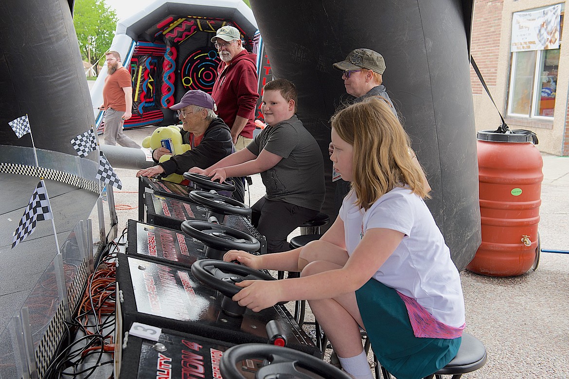 Aspiring drivers took miniature race cars for a spin during the St-Char-Ro anniversary celebration and street festival Saturday in Ronan. (Kristi Niemeyer/Leader)