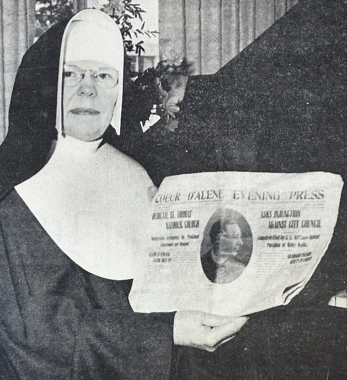 In May 1965, Sister M. Aloysia of Immaculate Heart of Mary Academy, displays a 1912 Coeur d’Alene Press photo of Rev. Thomas J. Purcell, the parish priest who built St. Thomas Catholic Church at Ninth and Indiana.