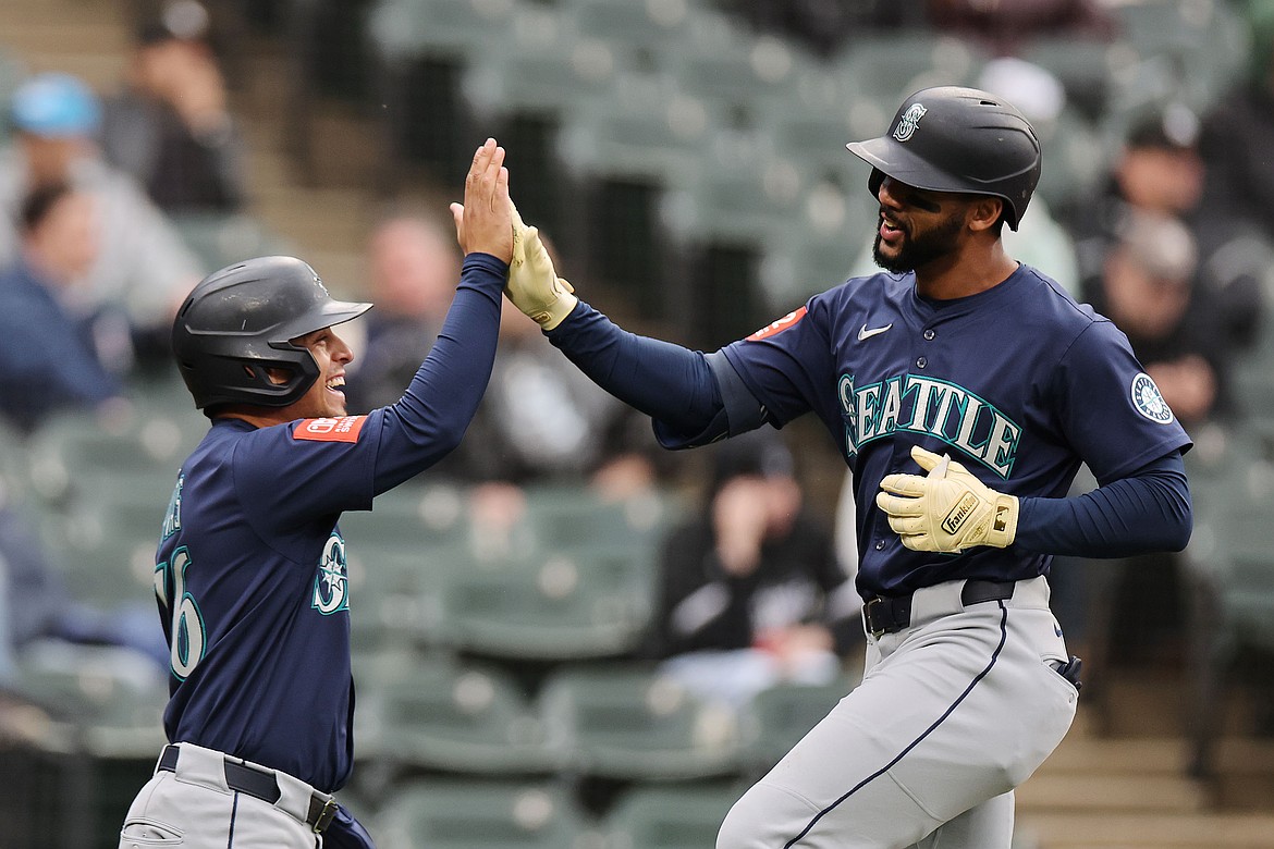 Leody Taveras (4) of the Seattle Mariners celebrates with Leo Rivas (76) after hitting a two-run home run against the Chicago White Sox during the eighth inning at Rate Field on May 21, 2025, in Chicago.