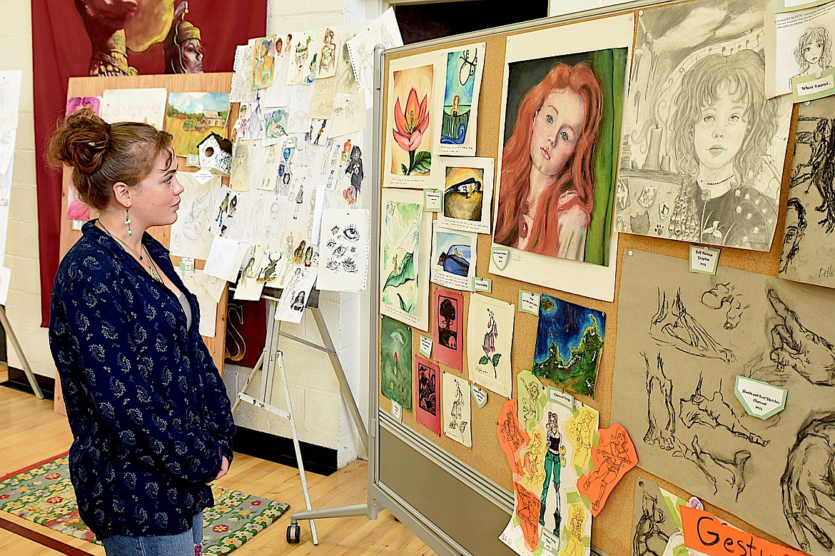 Troy High School senior Bella O'Day considers four years of creations at the school's annual student art show Tuesday, May 20, 2025. (Scott Shindledecker/The Western News)