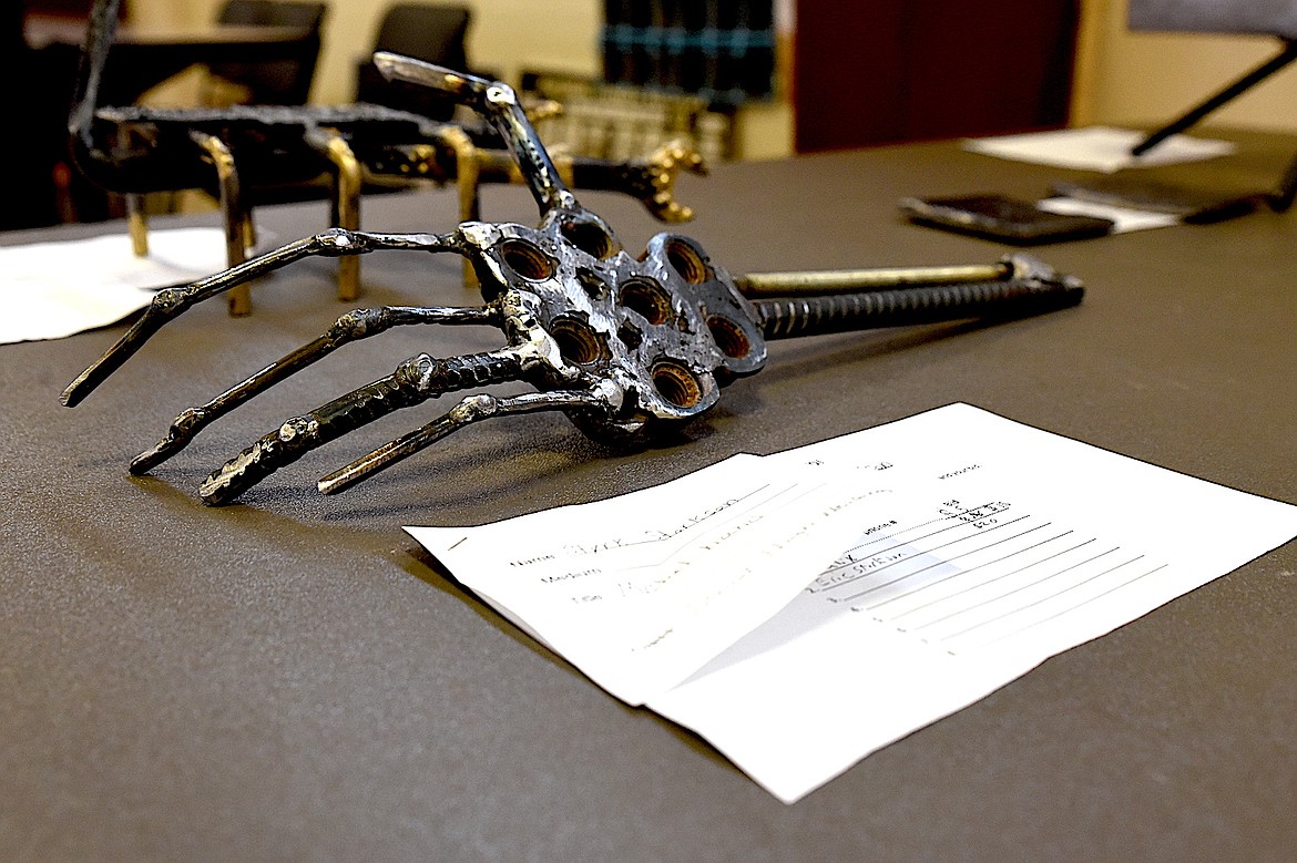 Troy junior high school student Styrk Storkson's welding of a metal hand cast a ghoulish look at the school's annual student art show Tuesday, May 20, 2025. (Scott Shindledecker/The Western News)