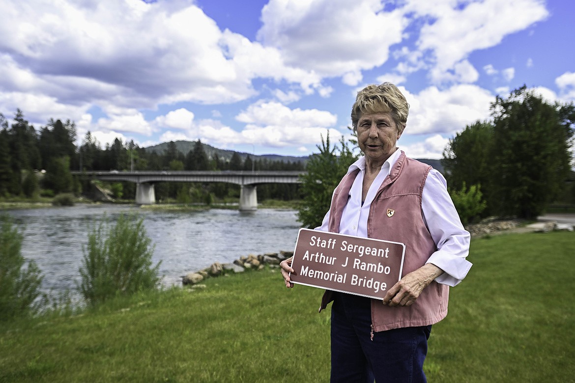 Patty Rambo, younger sister to Staff Sergeant Arthur J Rambo, stands in front of the bridge newly dedicated to her brother's memorial. (Kate Heston/Daily Inter Lake)