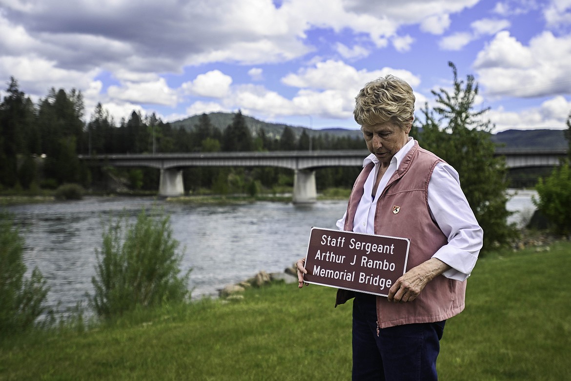 Patty Rambo, younger sister to Staff Sergeant Arthur J Rambo, stands in front of the bridge newly dedicated to her brother's memorial. (Kate Heston/Daily Inter Lake)