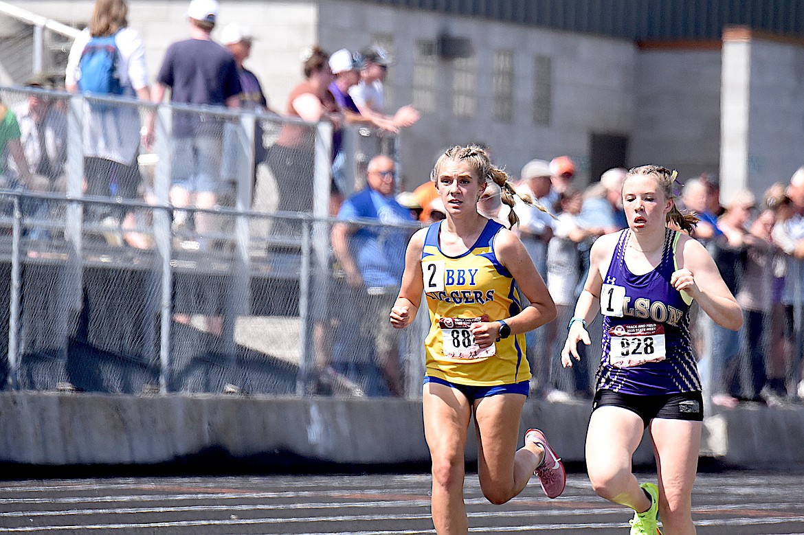 Libby's Capri Farmer, running with Polson's Morgan Delaney, was second in the Montana High School Association Class A 3,200-meter run Saturday, May 24, 2025, at Legends Stadium in Kalispell. (Scott Shindledecker/The Western News)