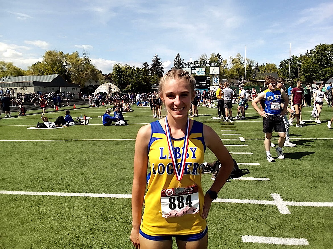 Libby's Capri Farmer shows off her silver medal after finishing second in the Montana High School Association Class A 3,200-meter run Saturday, May 24, 2025, at Legends Stadium in Kalispell. (Scott Shindledecker/The Western News)