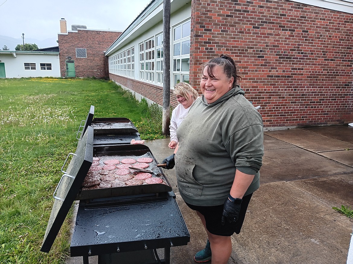 Buffy Cheeseman and Jennifer Cheeseman were flippin’ burgers and hotdogs in the drizzle for lunch that was served to students, staff, first responders, presenters and parents at the St. Regis Health Fair. (Monte Turner/Mineral Independent)
