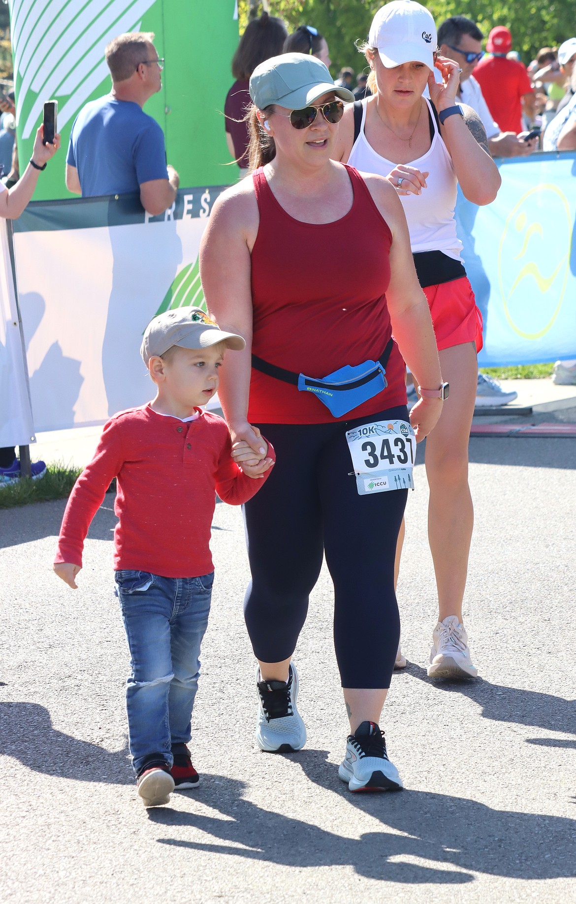 Jaylene Crosby of Coeur d’Alene was joined by son Thomas, 3, just before finishing the 10K on Sunday.