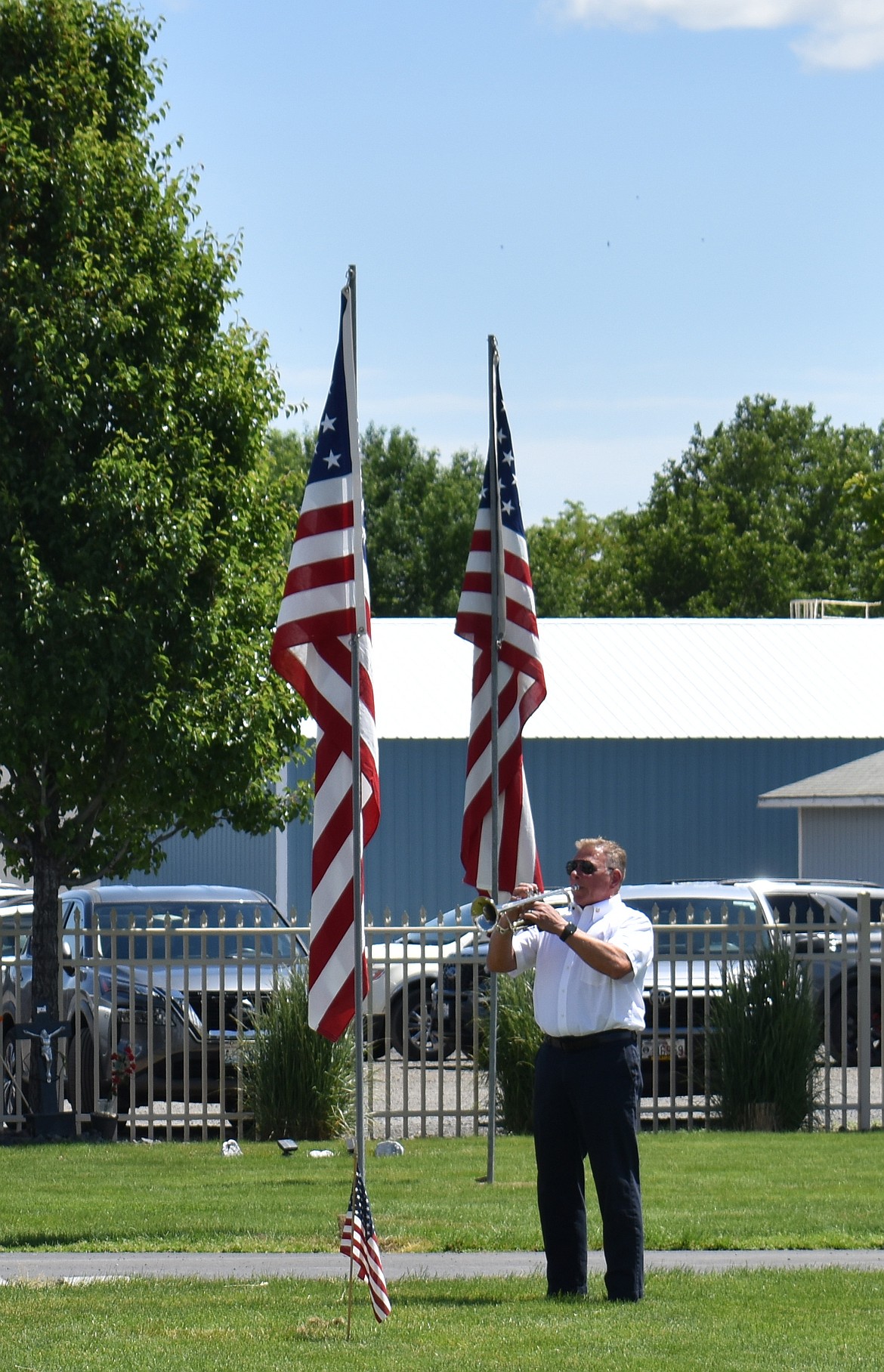 Bugler Greg Wright plays taps at the Memorial Day ceremony in Quincy Monday.
