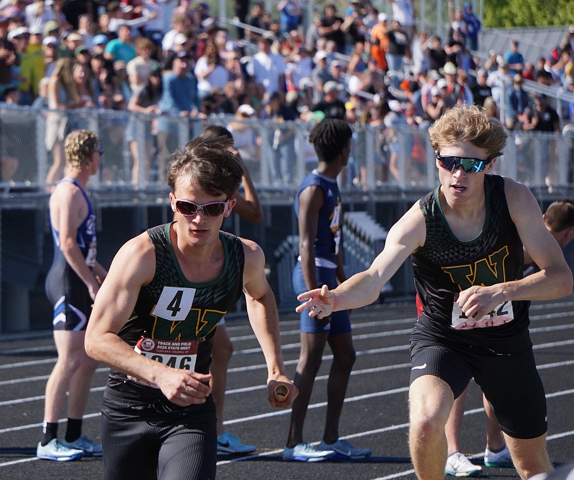 After receiving the baton from Ethan Amick, Simon Douglas sprints away on the final leg of the Men's 4X400 Relay . The squad would finish first overall on their last race as Whitefish Bulldogs. (Matt Weller photo)