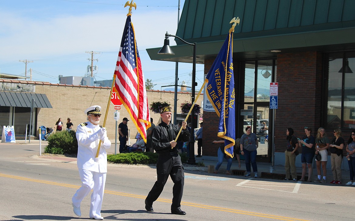 Flag were presented as watchers stood in respect at Monday's Memorial Day parade. (Kaleb Unger/Leader)