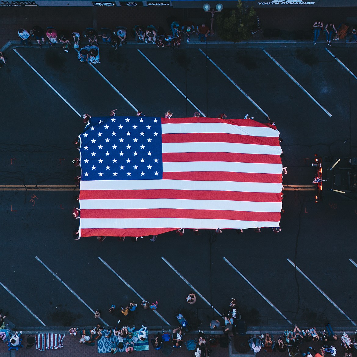 Moses Lake JROTC students carry a giant U.S. flag in the Moses Lake Spring Fest Grand Parade Saturday night. The students also volunteered to help the committee with setting up, tearing down and cleaning up, which lightened the committee’s burden considerably.