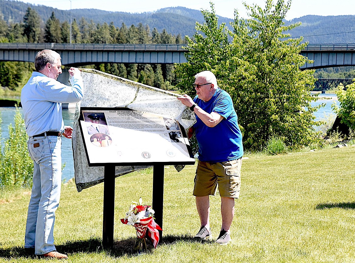 Montana Governor Marc Racicot and Marv Sather unveil the Arthur J Rambo Memorial during a ceremony Sunday, May 25, 2025, at Riverfront Park in Libby, Montana. (Scott Shindledecker/The Western News)