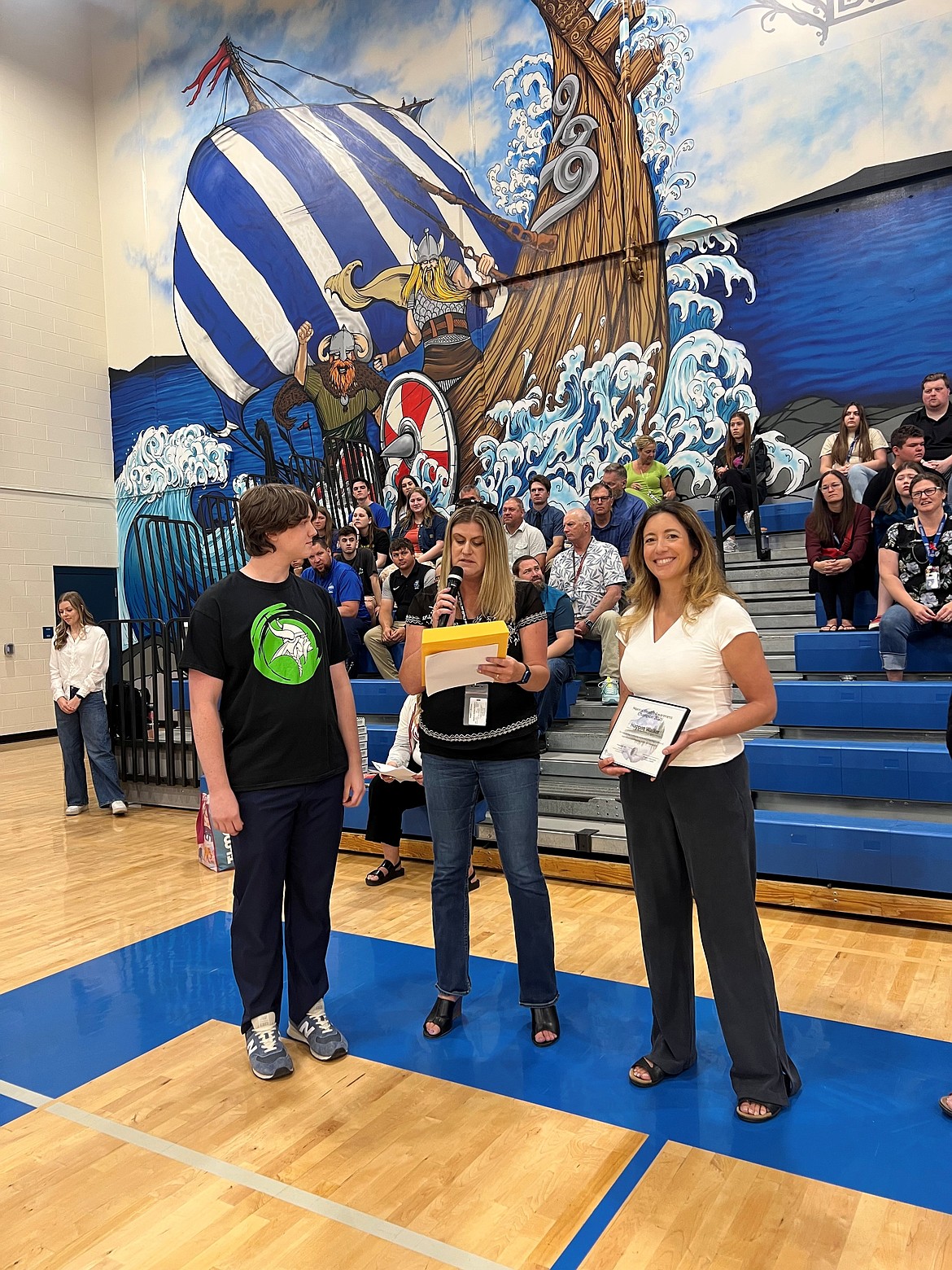 Maggie Morrison introduces Haggen Walker as the North Idaho's student Mental Health Champion Tuesday at Coeur d'Alene High School. Rosa Mettler holds the award before presenting it during an award ceremony.