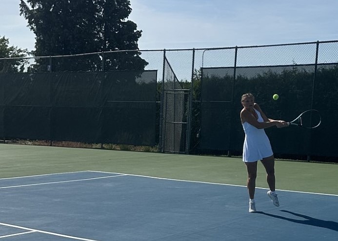 Madi Christensen preparing to return the ball at the state tournament. She plans on attending BYU to study interior and landscape design.