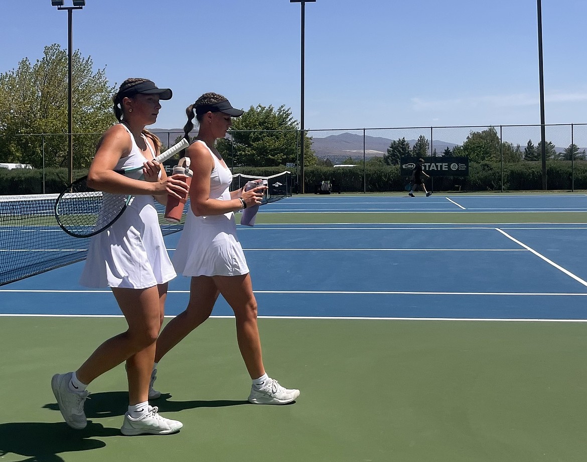 The Knights girls doubles duo Madi Christensen and Campbelle Anderson walk change ends following one of their sets. The girls started their tennis careers in eighth grade and have grown to love the sport every day since.