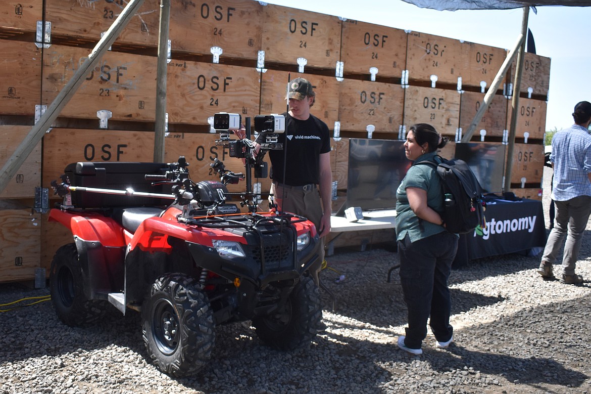 Spencer Rickel from Vivid Machines shows off an ATV with multiple cameras mounted on top that can be used to assist in farm management.