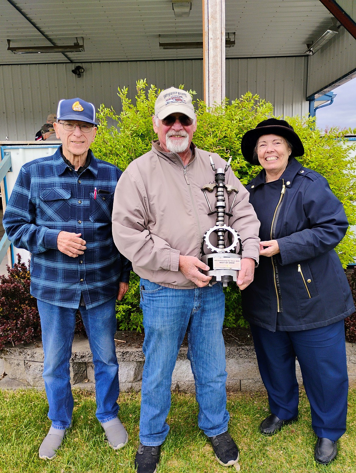 Paul Brock stands with Marchella Layton and Chuck Rose after winning two trophies at the Rathdrum car show in May.