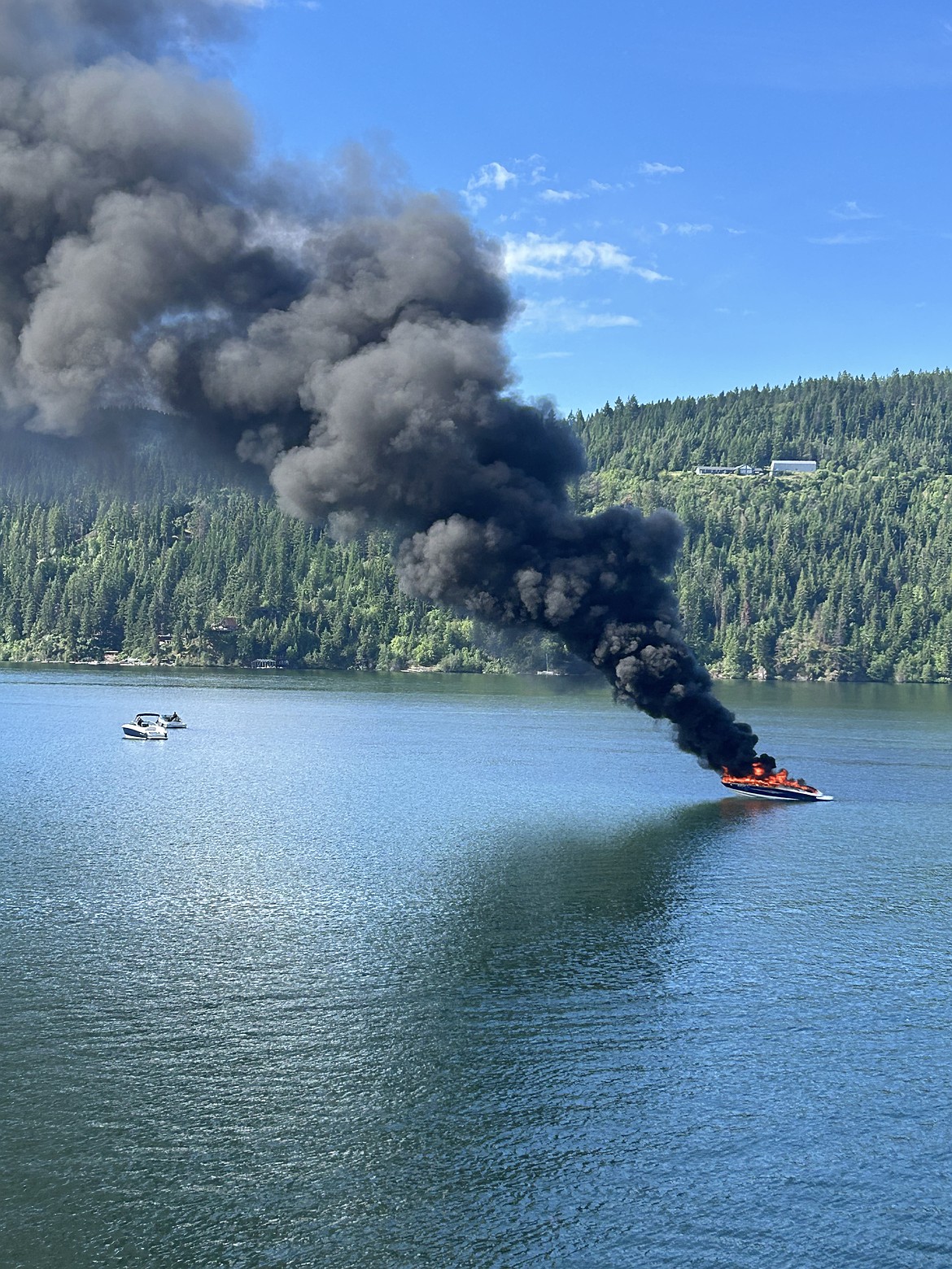 Smoke rises from a burning boat near Higgens Point on Saturday morning.
