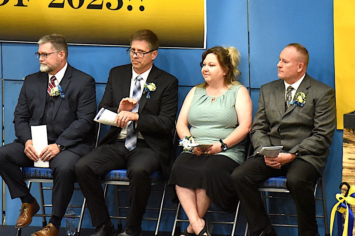 Lincoln County District Judge Matt Cuffe, Libby High School Principal Ron Goodman, School Trustee President Alida Snow and high school Principal Scott Beagle wait their respective turns to participate in graduation ceremonies Saturday, May 31, 2025, in Ralph Tate Gymnasium. (Scott Shindledecker/The Western News)