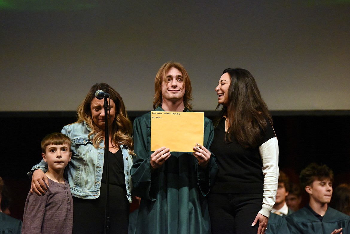 Levi Wilson receives the John Michael Memorial Scholarship from Michael's family members. (Kelsey Evans/Whitefish Pilot)
