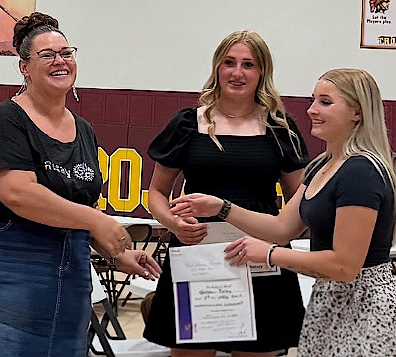 The Rotary Club of Kootenai Valley's Tabitha Viergutz presented $1,000 scholarships to Troy High School seniors Autumn Fisher and Cortenie Rogers at last week's awards assembly. (Courtesy photo)