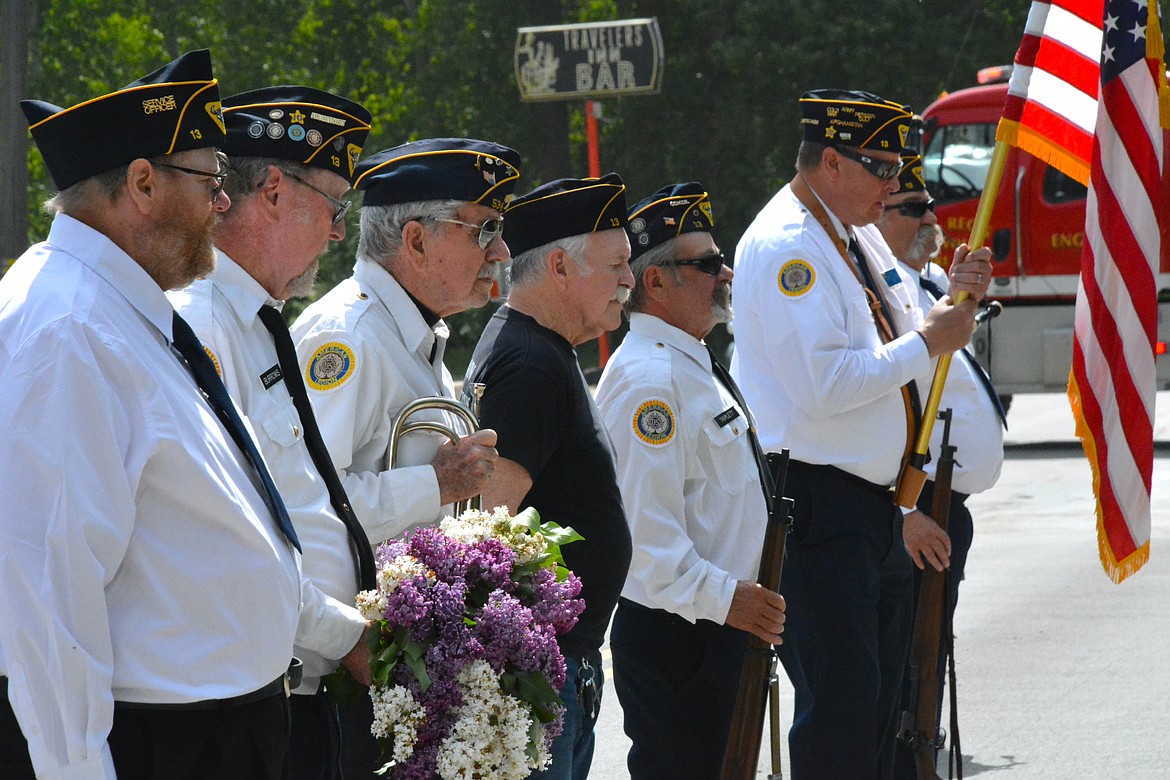 During the Memorial Day ceremony, a handmade wreath of fresh lilacs blooms is tossed into the St. Regis River as a symbolic act of honoring and remembering service members who lost their lives at sea. (Mineral Independent/Amy Quinlivan)