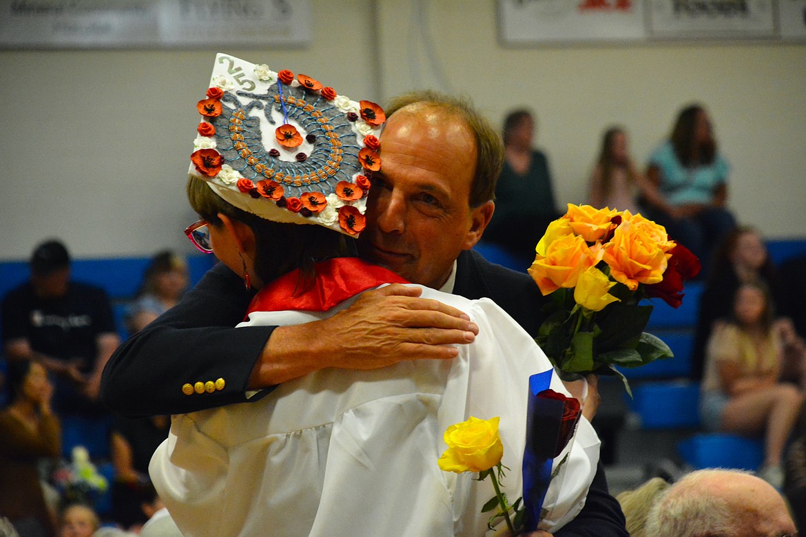 The rose ceremony, which should be dubbed the "Kleenex ceremony," allows graduating seniors to display a token of appreciation to all their family, friends, teachers, and coaches who supported them on their journey. Emma Lommen presented high school history teacher, Colin Bishop, with a rose and a thank you. (Mineral Independent/Amy Quinlivan)