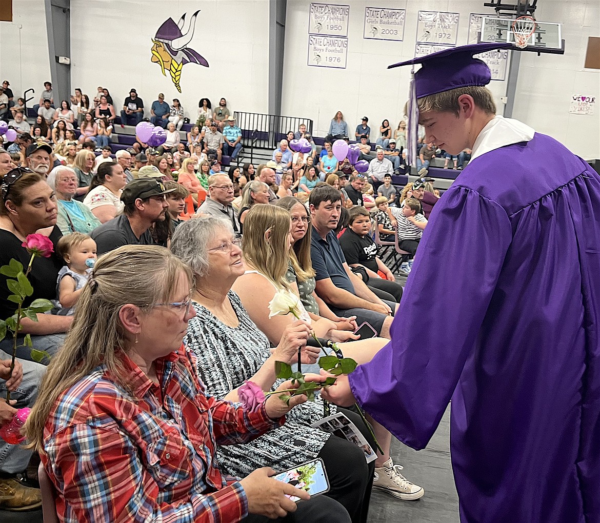 Charlo salutatorian Adam Sheumaker gives roses to his family after receiving his diploma Sunday. (Kristi Niemeyer/Leader)