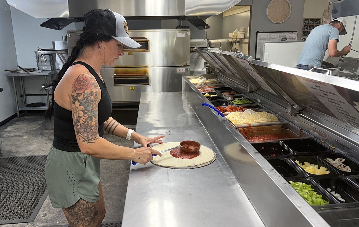 Courtney Moran is a hands-on owner at Arlee's Pigasus Pizza who is actively involved in the pizza making process. (Kaleb Unger/Leader)
