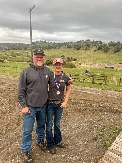 4-H Archery Coach, Rusty Parkin, give's 'Jimmie' Kelly a hug during a practice shoot last month. (Photo provided)