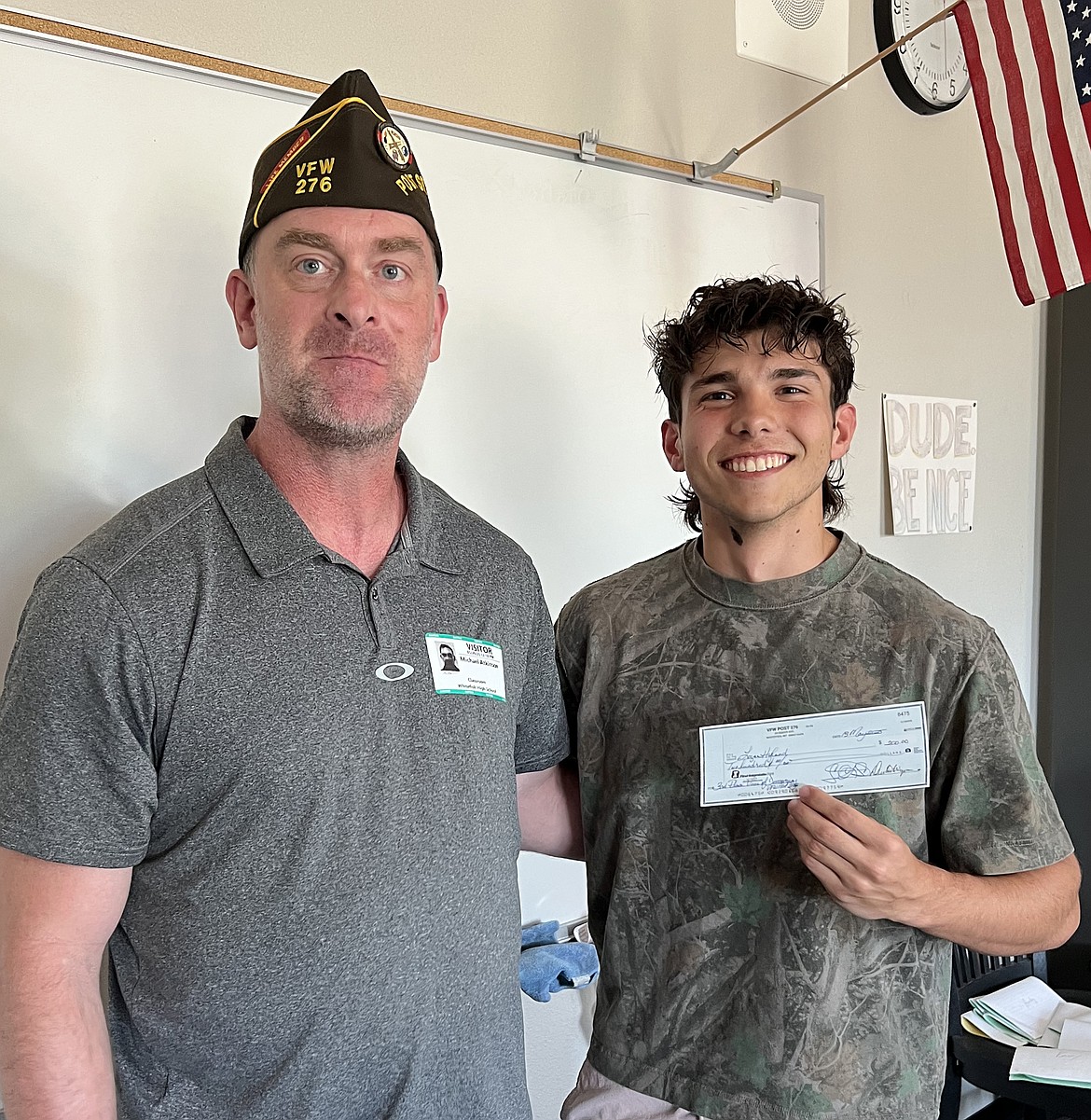 Logan Hyland accepts the third-place prize from Mike Atkinson for the VFW Post 276 essay contest. (Vanessa Solomon photo)
