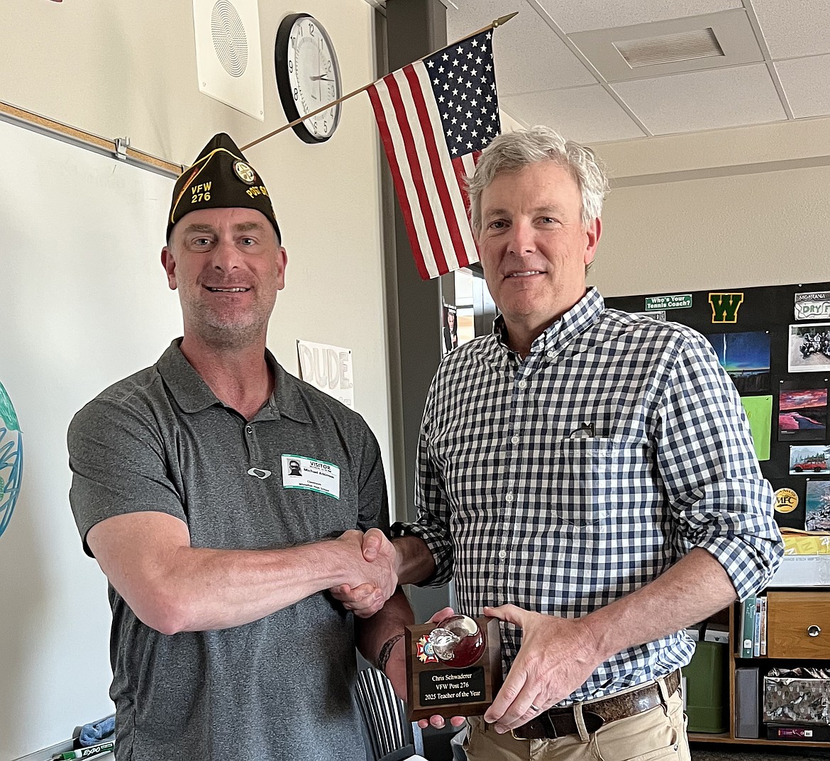 Mike Atkinson presents Chris Schwaderer with the VFW Post 276 2025 Teacher of the Year award. (Vanessa Solomon photo)