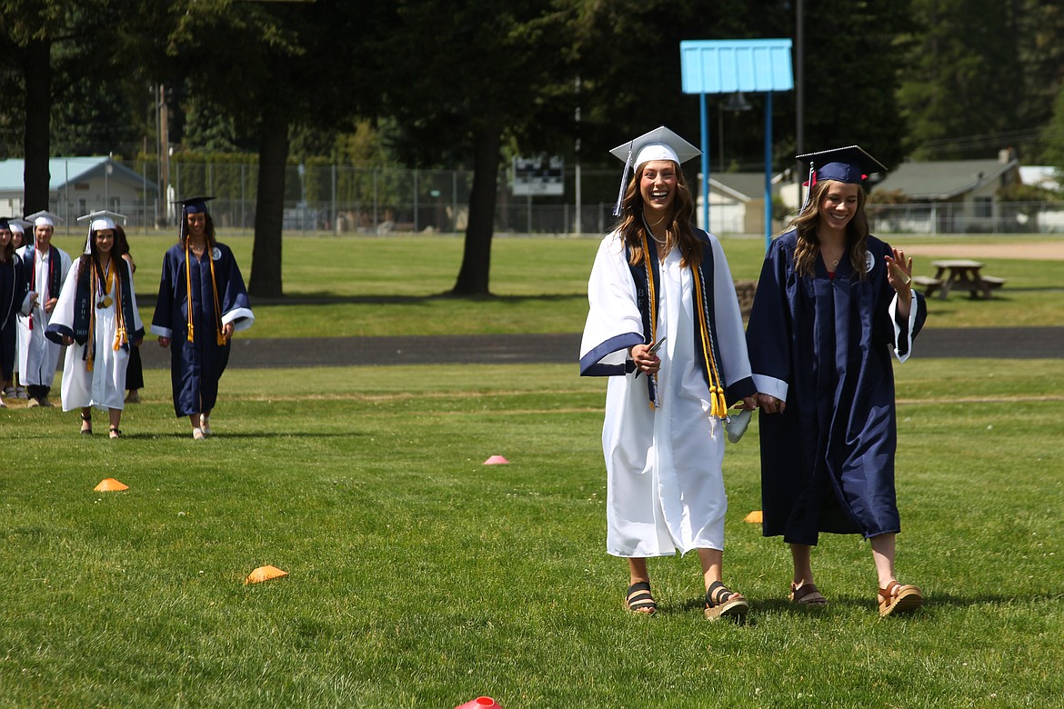 Bonners Ferry High School graduates smile as they walk into Mendenhall Stadium for the Class of 2025's commencement ceremony.