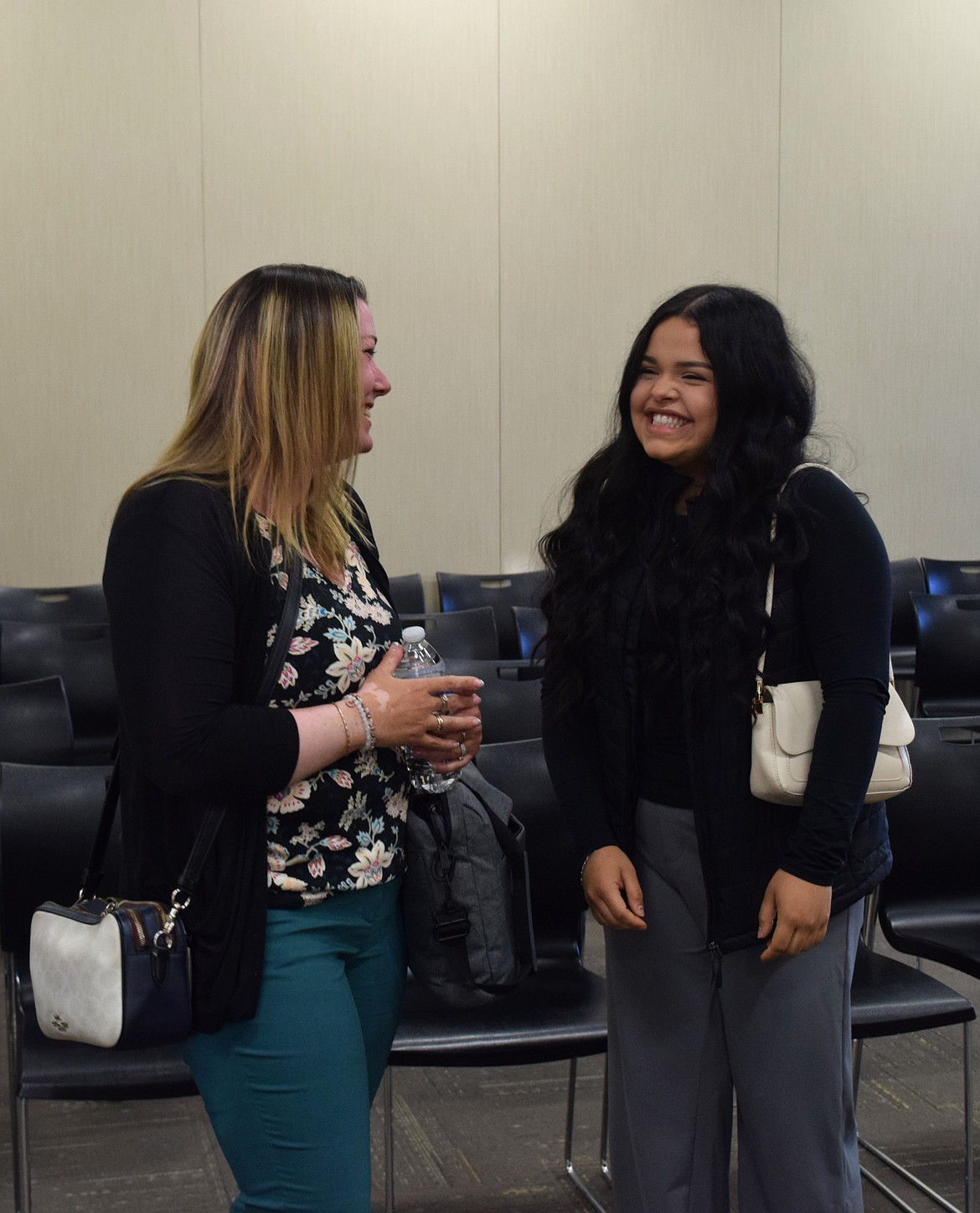 New Student Board Representative Angie Hernandez talks with School Board Member Carla Urias after the Thursday school board meeting. Hernandez will be a junior at the Digital Learning Center this upcoming school year.