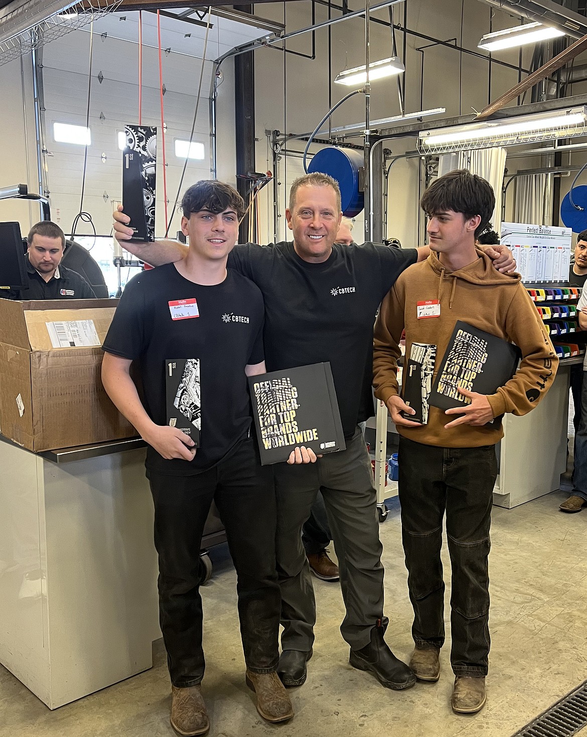 From left: CBTECH student Roan Prentice, instructor Lonny Steinmetz and student David Couture at the Top Tech Challenge in Yakima. Prentice took first place and Couture took second.