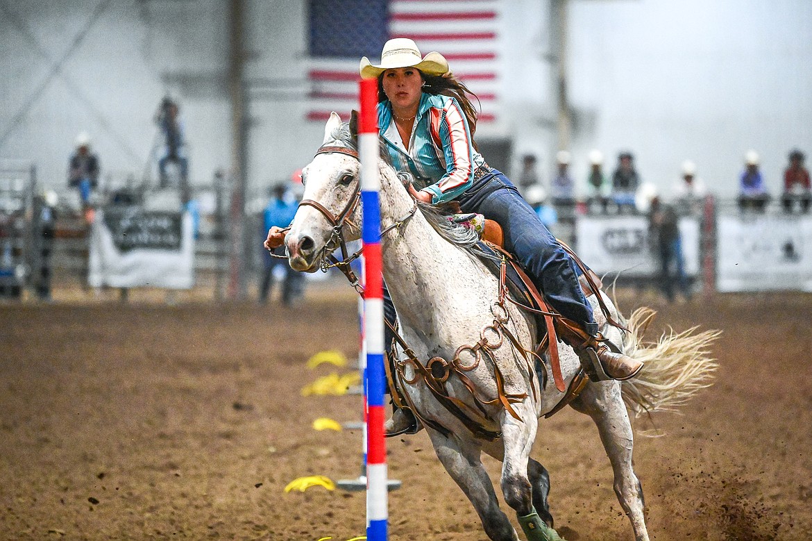Ruby Ray, from Whitefish, weaves her horse through the pattern in pole bending at the Montana High School Rodeo Association Finals at Majestic Valley Arena on Thursday, June 5. (Casey Kreider/Daily Inter Lake)