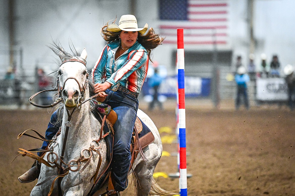Ruby Ray, from Whitefish, weaves her horse through the pattern in pole bending at the Montana High School Rodeo Association Finals at Majestic Valley Arena on Thursday, June 5. (Casey Kreider/Daily Inter Lake)
