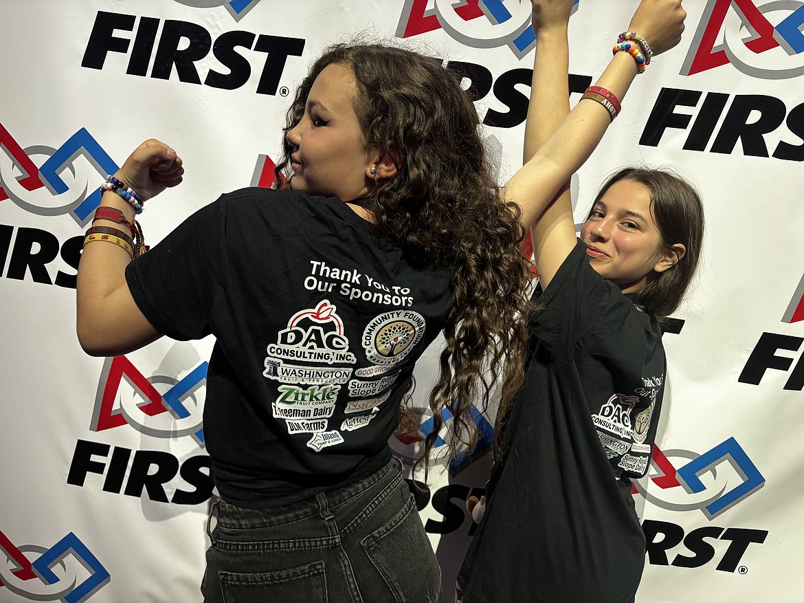 A very triumphant Lilly Piper, left, and Eva Villa show off their Oceanic Outlaws T-shirts at the Western Edge Open robotics competition.