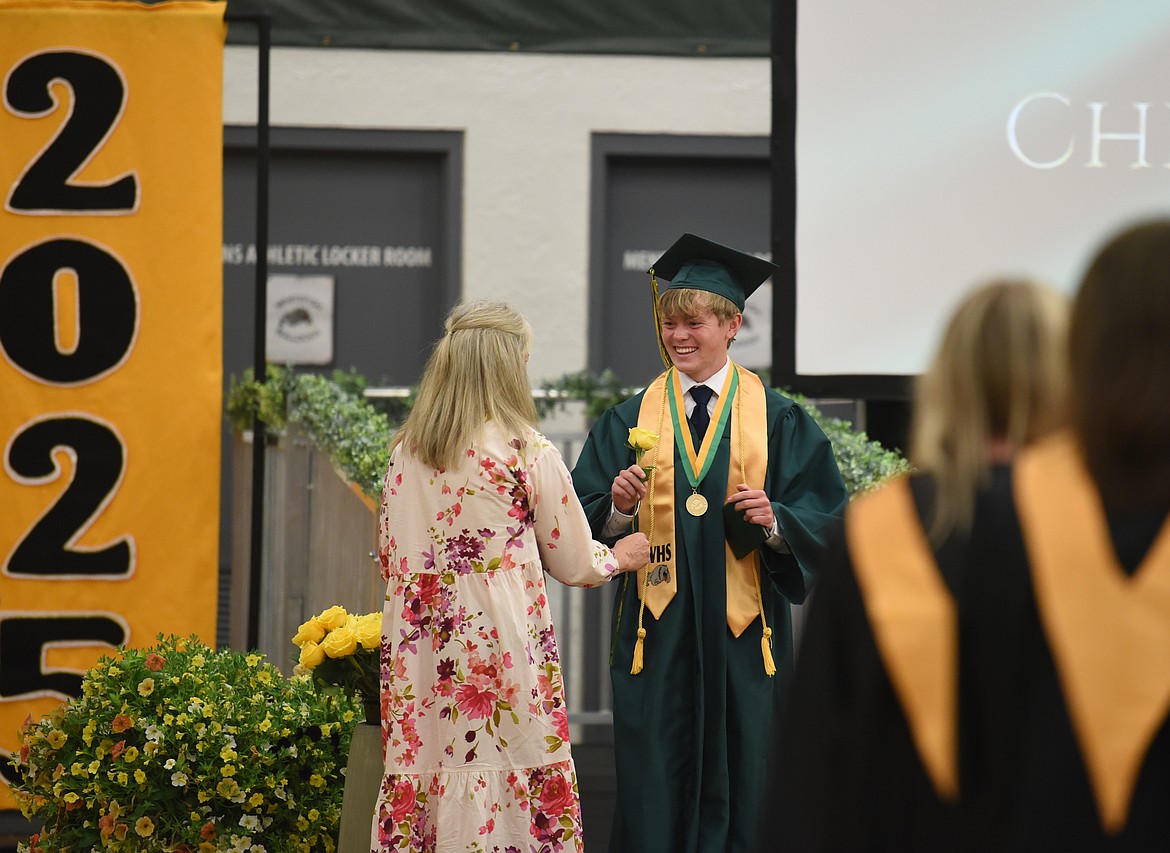 A graduate receives their yellow rose. (Kelsey Evans/Whitefish Pilot)