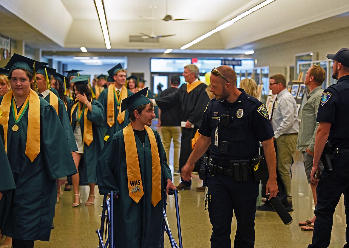 Students file out to the field for the cap toss. (Kelsey Evans/Whitefish Pilot)