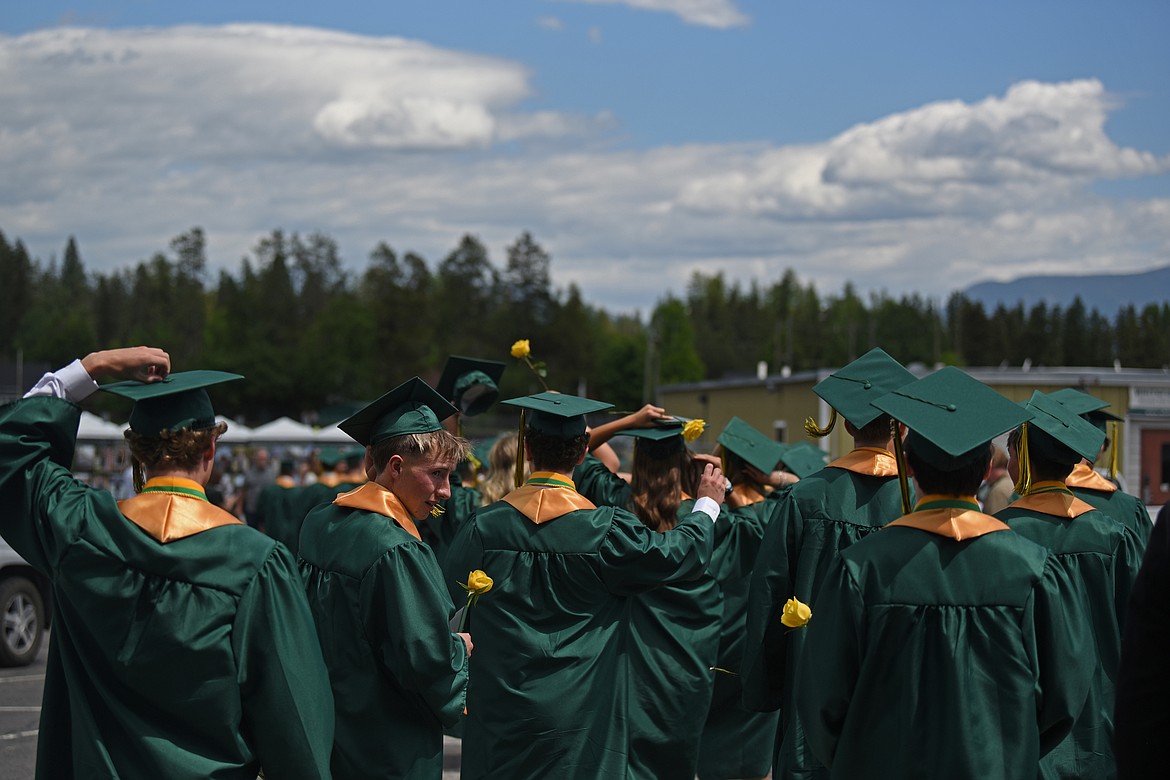 Graduates head outside for the cap toss. (Kelsey Evans/Whitefish Pilot)