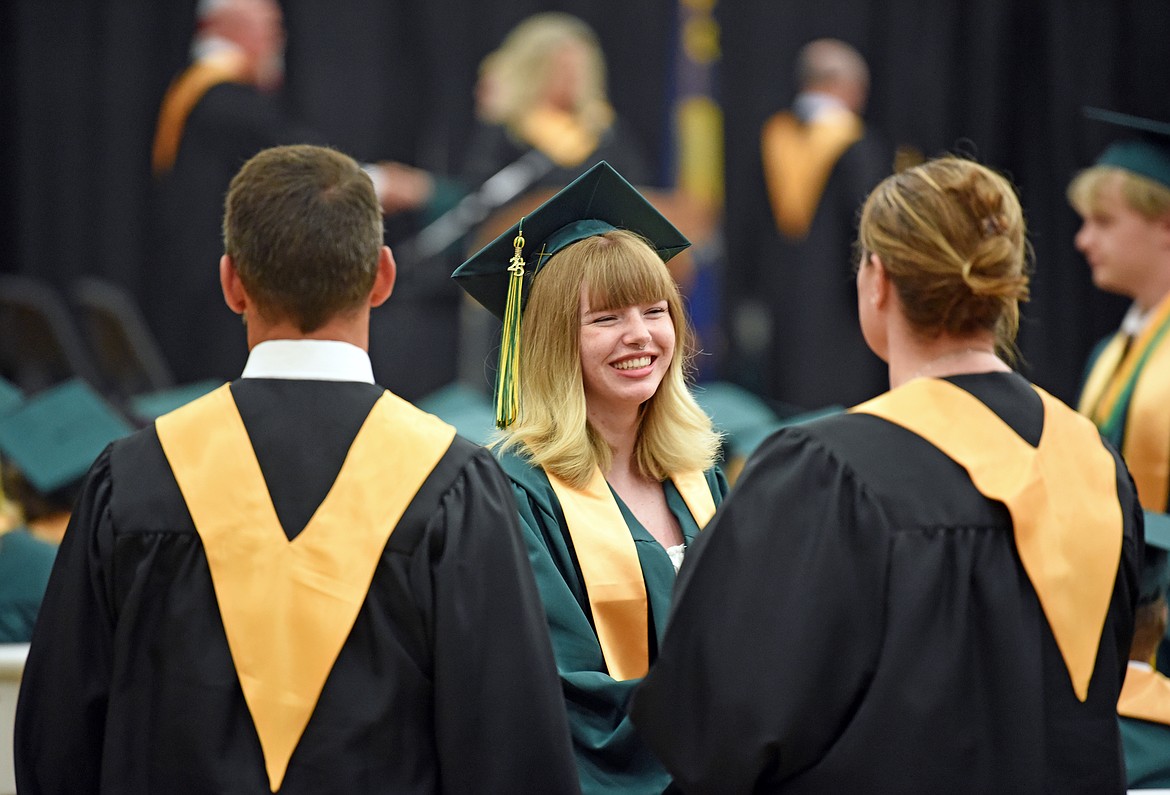 A graduate gives handshakes to teachers after receiving their diploma. (Kelsey Evans/Whitefish Pilot)
