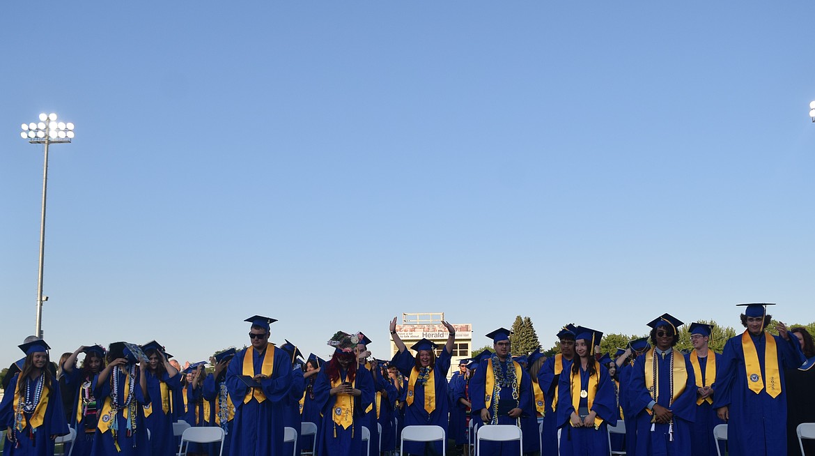 Students finish turning their tassels from right to left at the Vanguard Academy Graduation Wednesday. This was the school's first graduation ceremony.