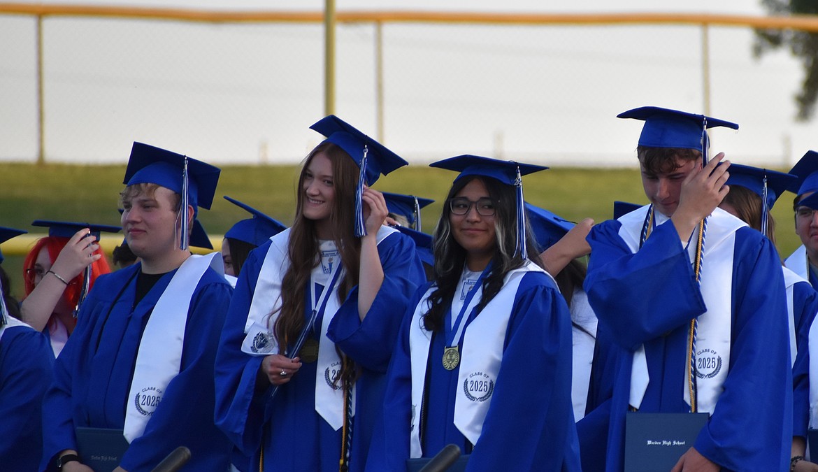 Graduates from Warden High School’s 2025 class turn over their tassels Friday evening.