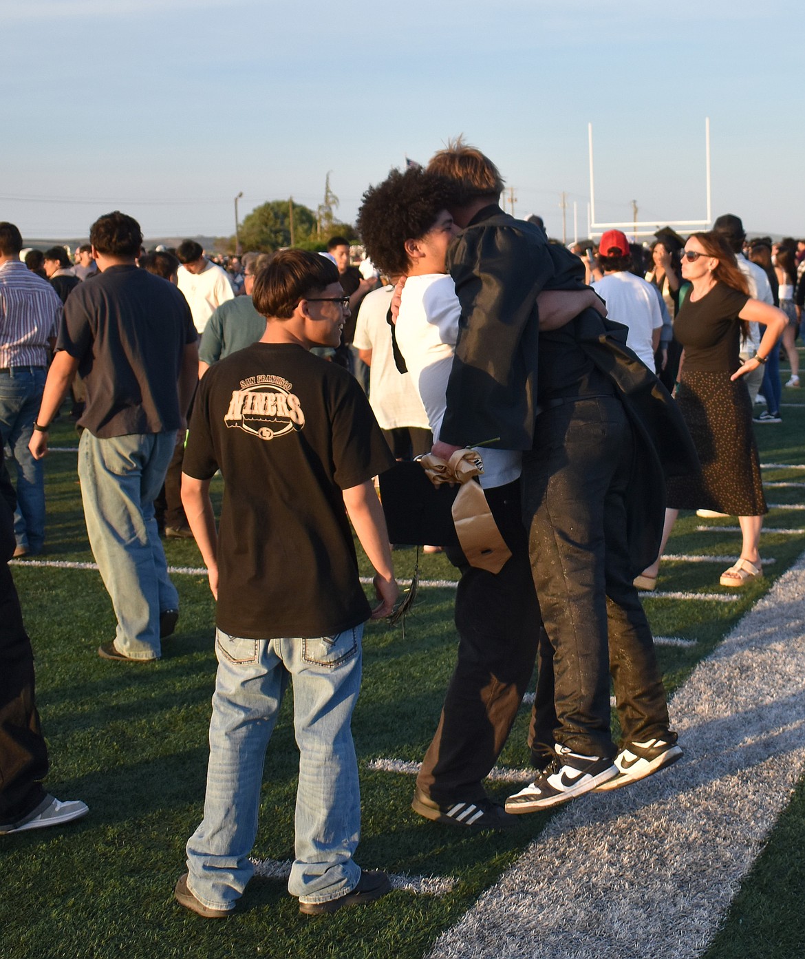 David Sotelo’s giant bear hug lifts new Royal High School graduate Tristan Tremblay off the ground at Royal’s graduation Friday.